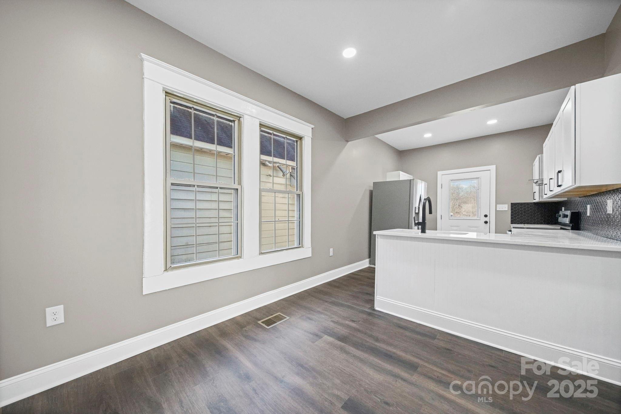 113 7th Street Spencer, NC 28159 - Photo 19 of 44 a view of kitchen with wooden floor and window