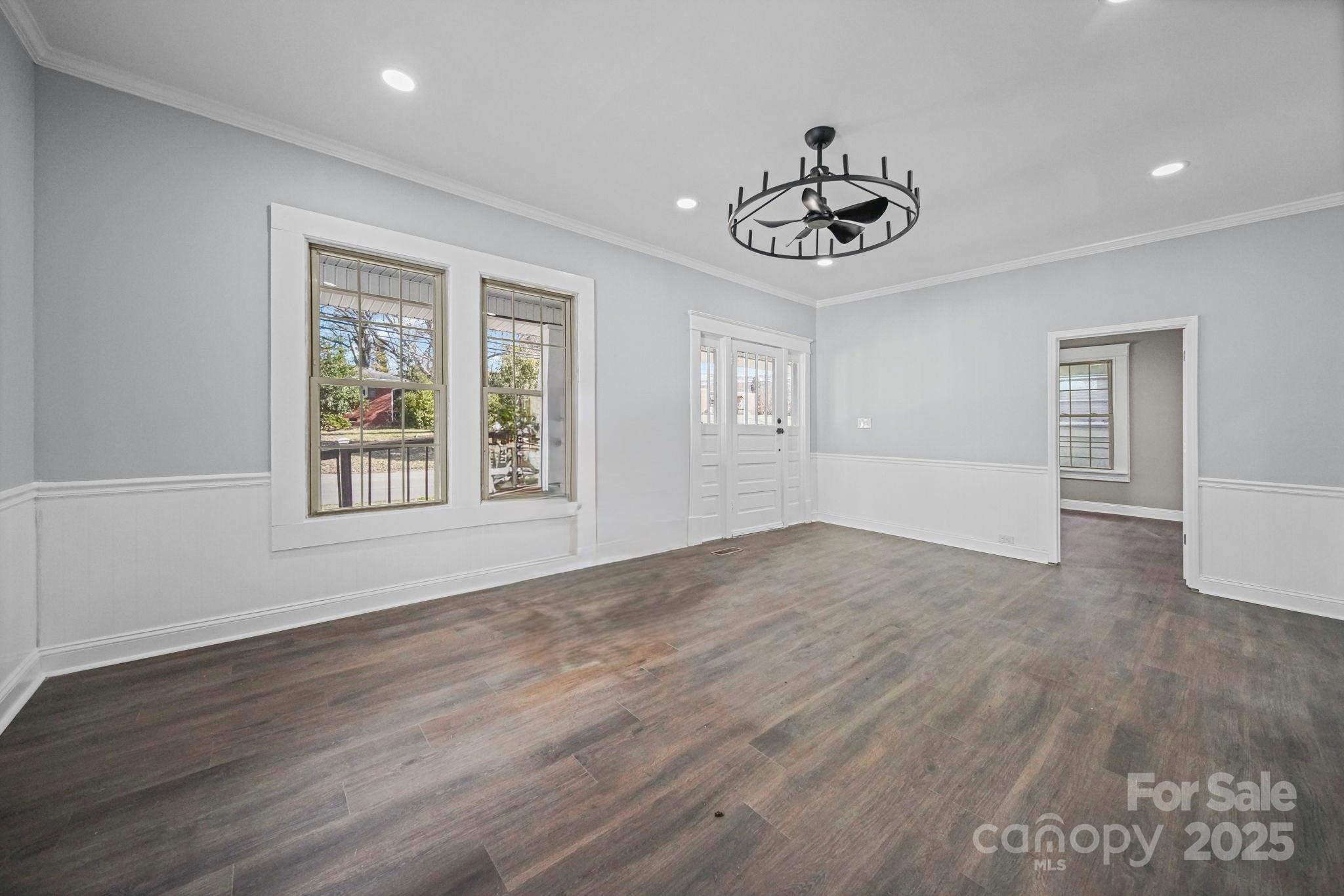 113 7th Street Spencer, NC 28159 - Photo 21 of 44 a view of an empty room with window and wooden floor
