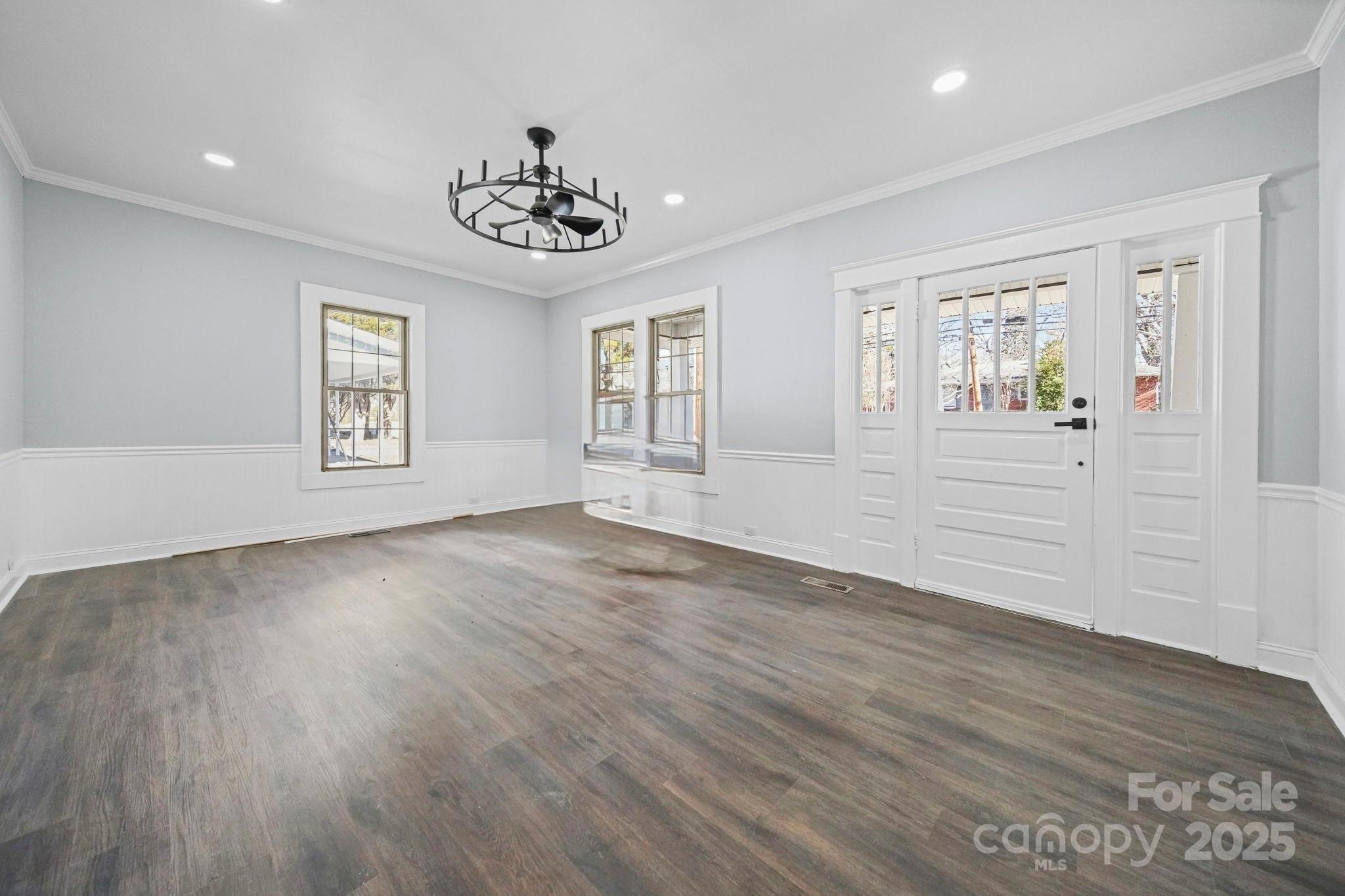 113 7th Street Spencer, NC 28159 - Photo 24 of 44 a view of an empty room with wooden floor and window