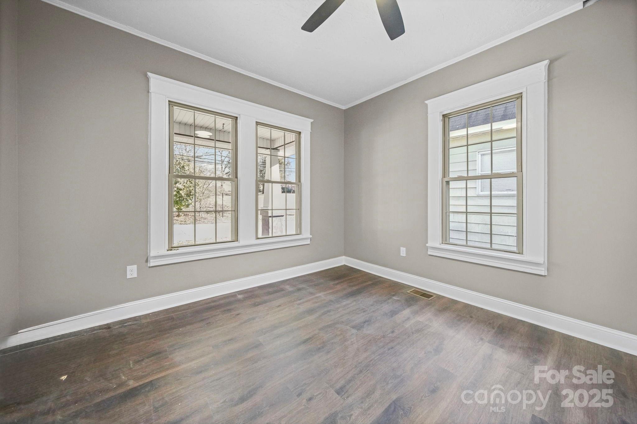 113 7th Street Spencer, NC 28159 - Photo 27 of 44 a view of an empty room with window and wooden floor
