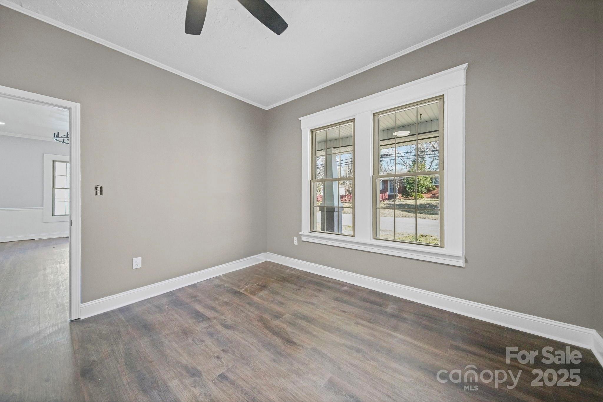 113 7th Street Spencer, NC 28159 - Photo 28 of 44 a view of an empty room with window and wooden floor