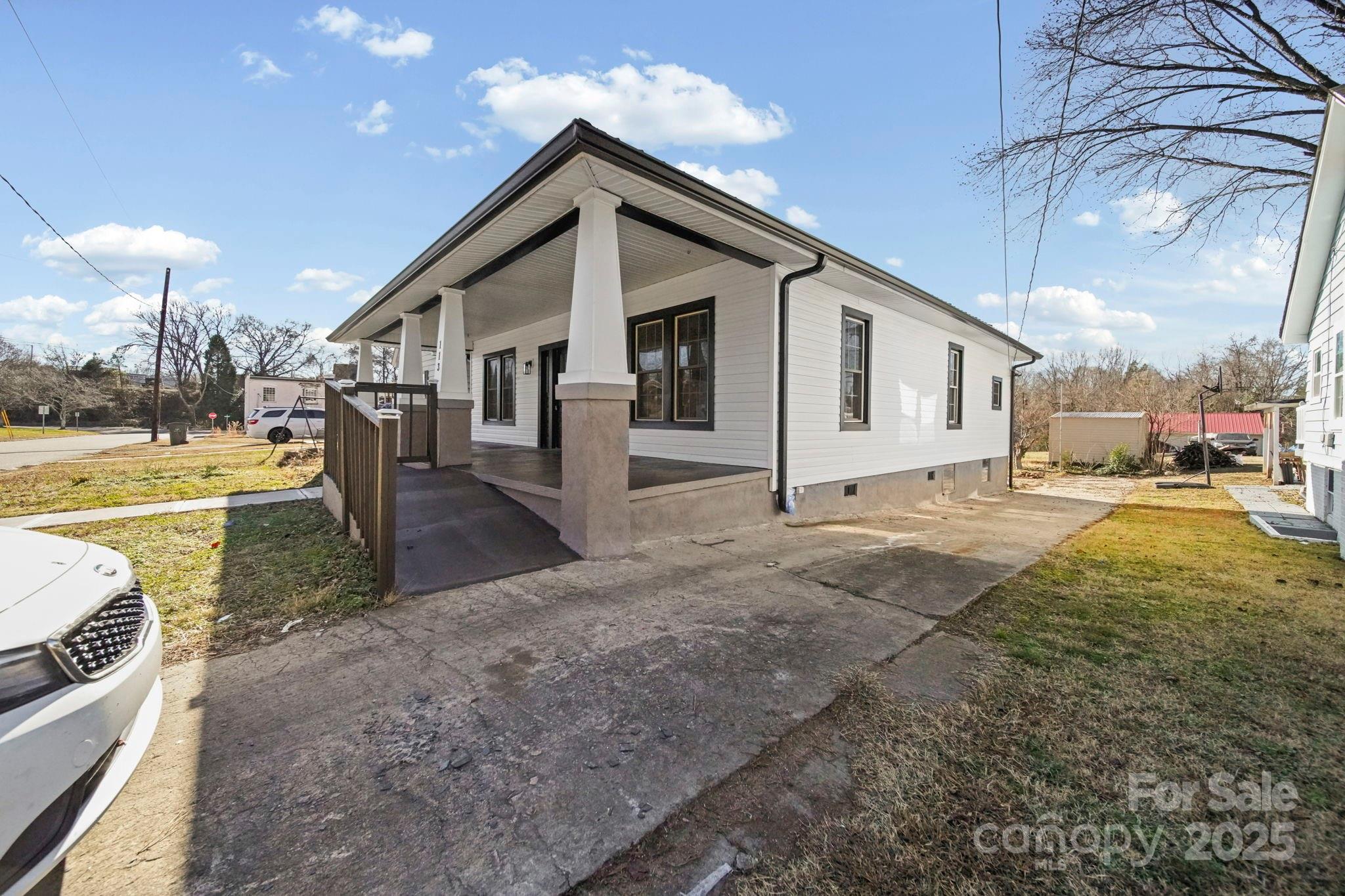 113 7th Street Spencer, NC 28159 - Photo 3 of 44 a view of a house with a yard