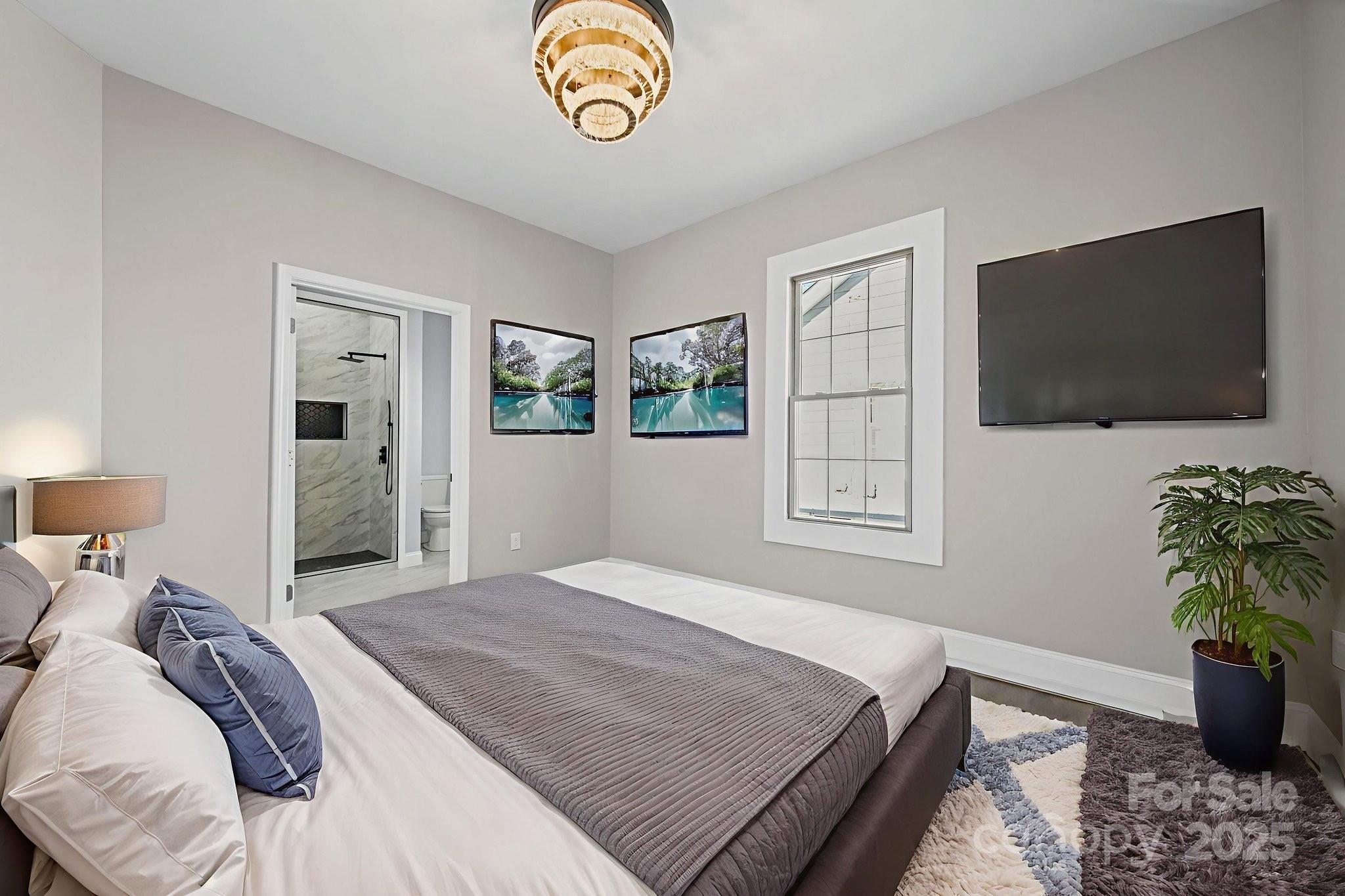 113 7th Street Spencer, NC 28159 - Photo 36 of 44 a bedroom with a bed and a flat screen tv