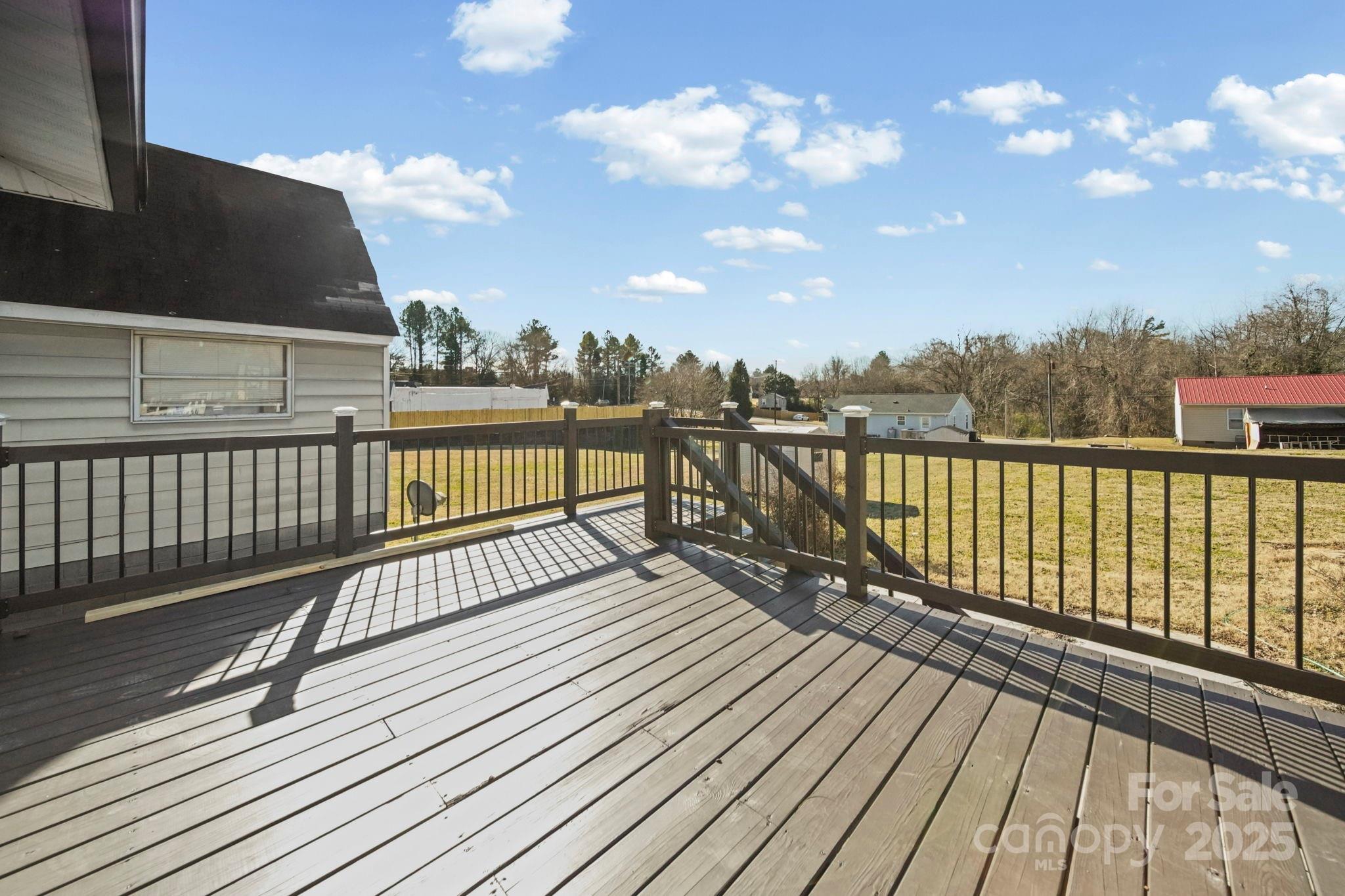 113 7th Street Spencer, NC 28159 - Photo 38 of 44 a view of wooden balcony with city view