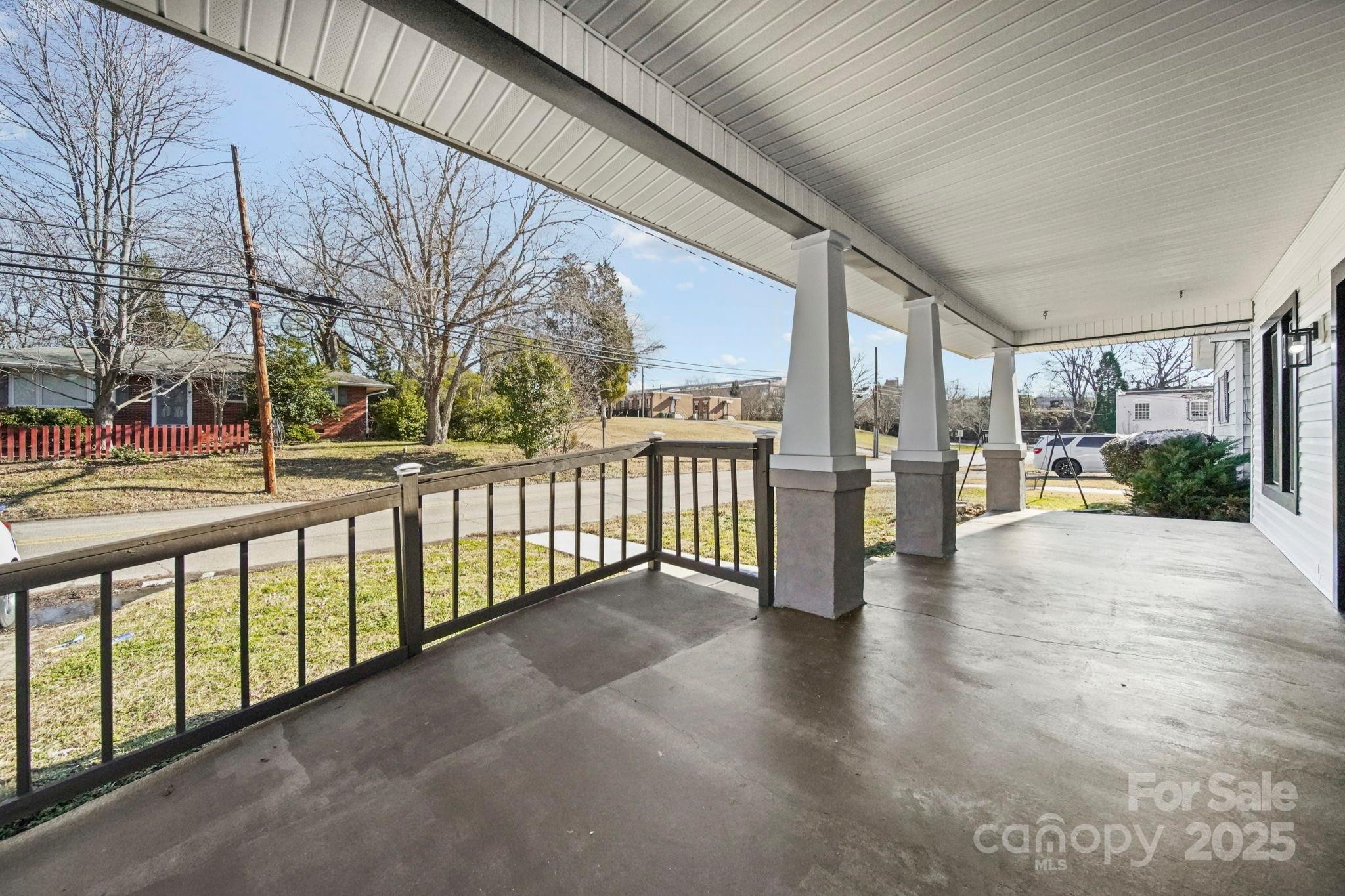 113 7th Street Spencer, NC 28159 - Photo 39 of 44 a view of a porch with wooden floor and fence