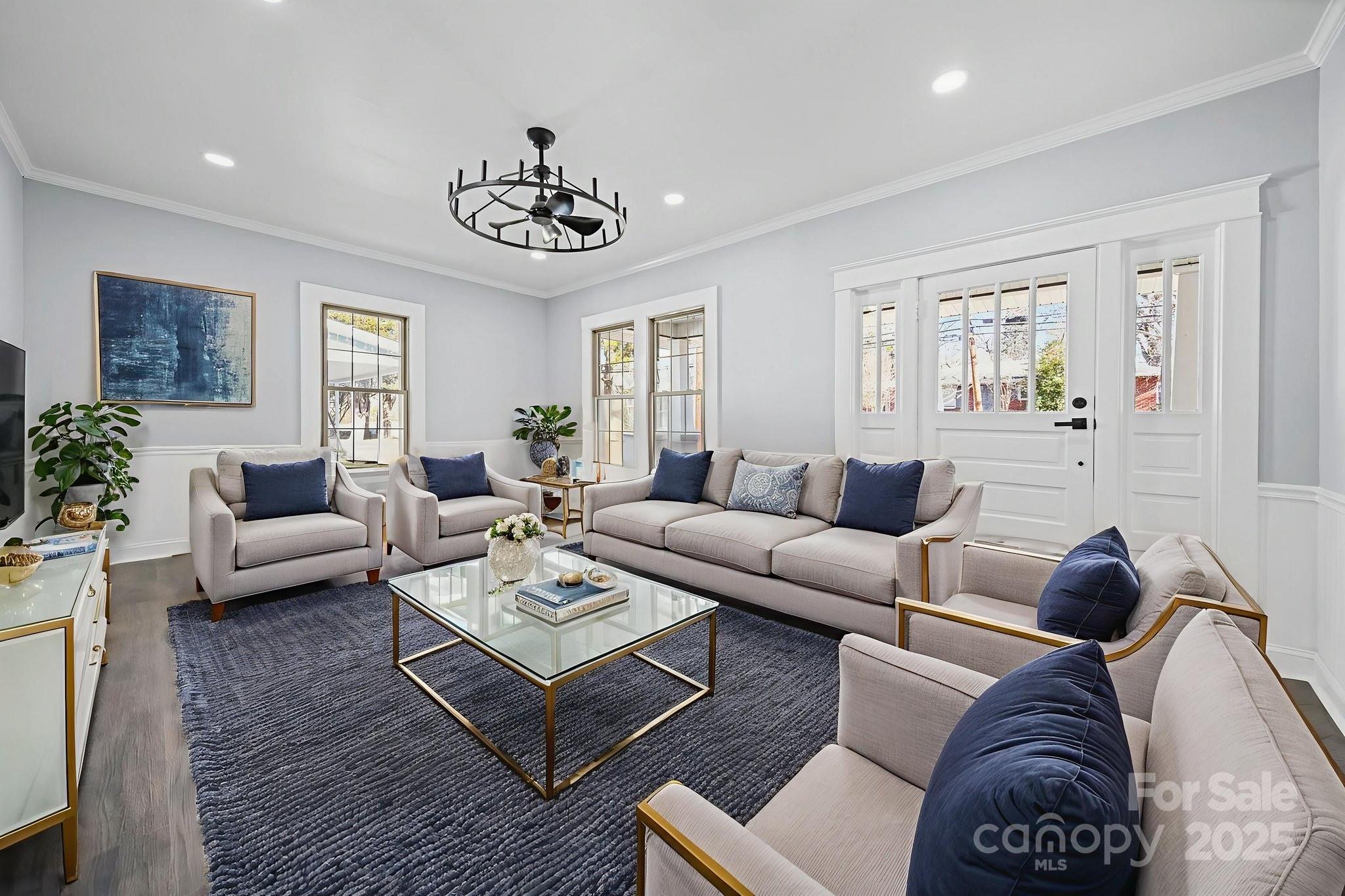 113 7th Street Spencer, NC 28159 - Photo 40 of 44 a living room with furniture a wooden floor and a chandelier