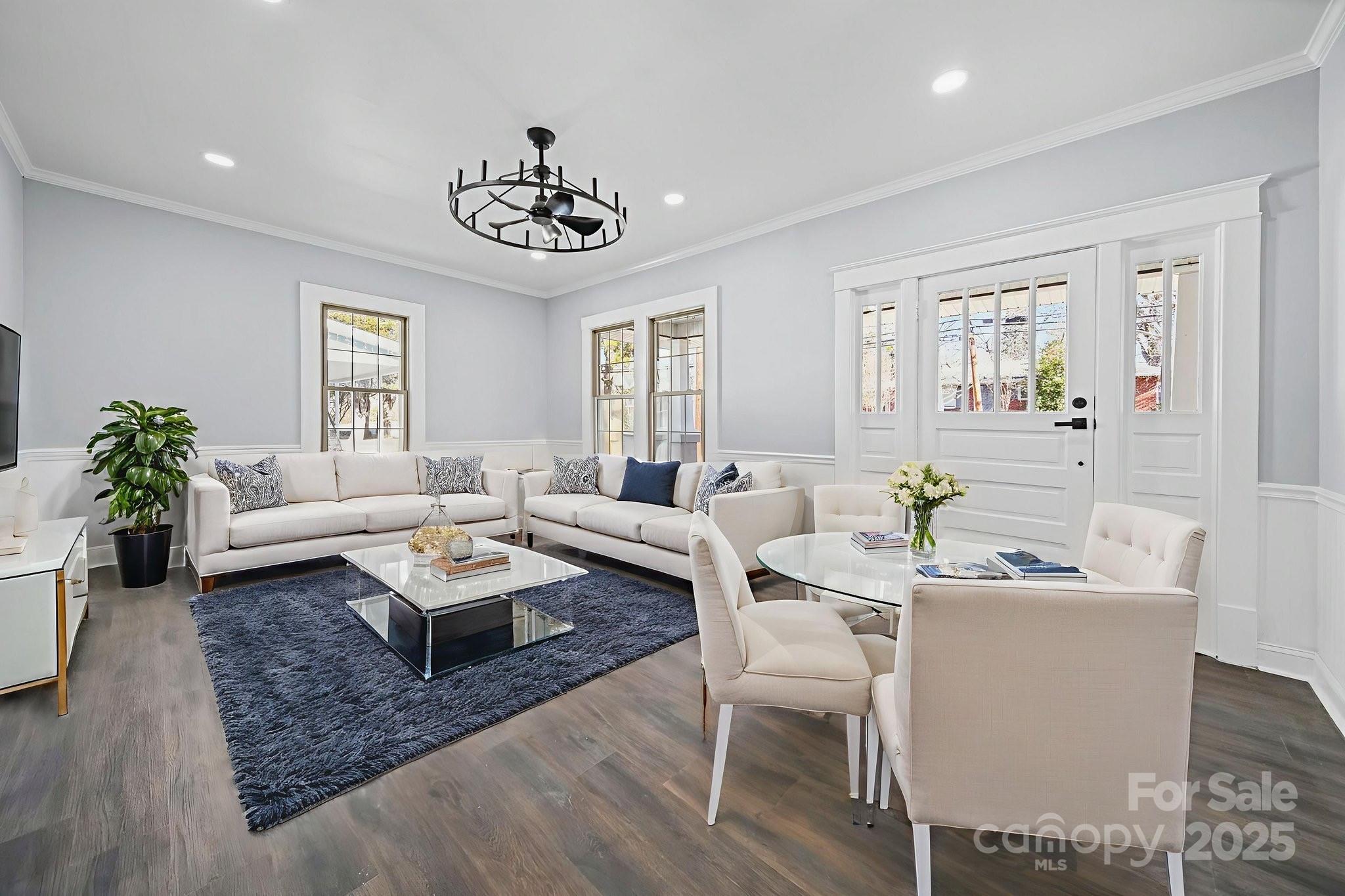113 7th Street Spencer, NC 28159 - Photo 42 of 44 a living room with furniture a chandelier and a table