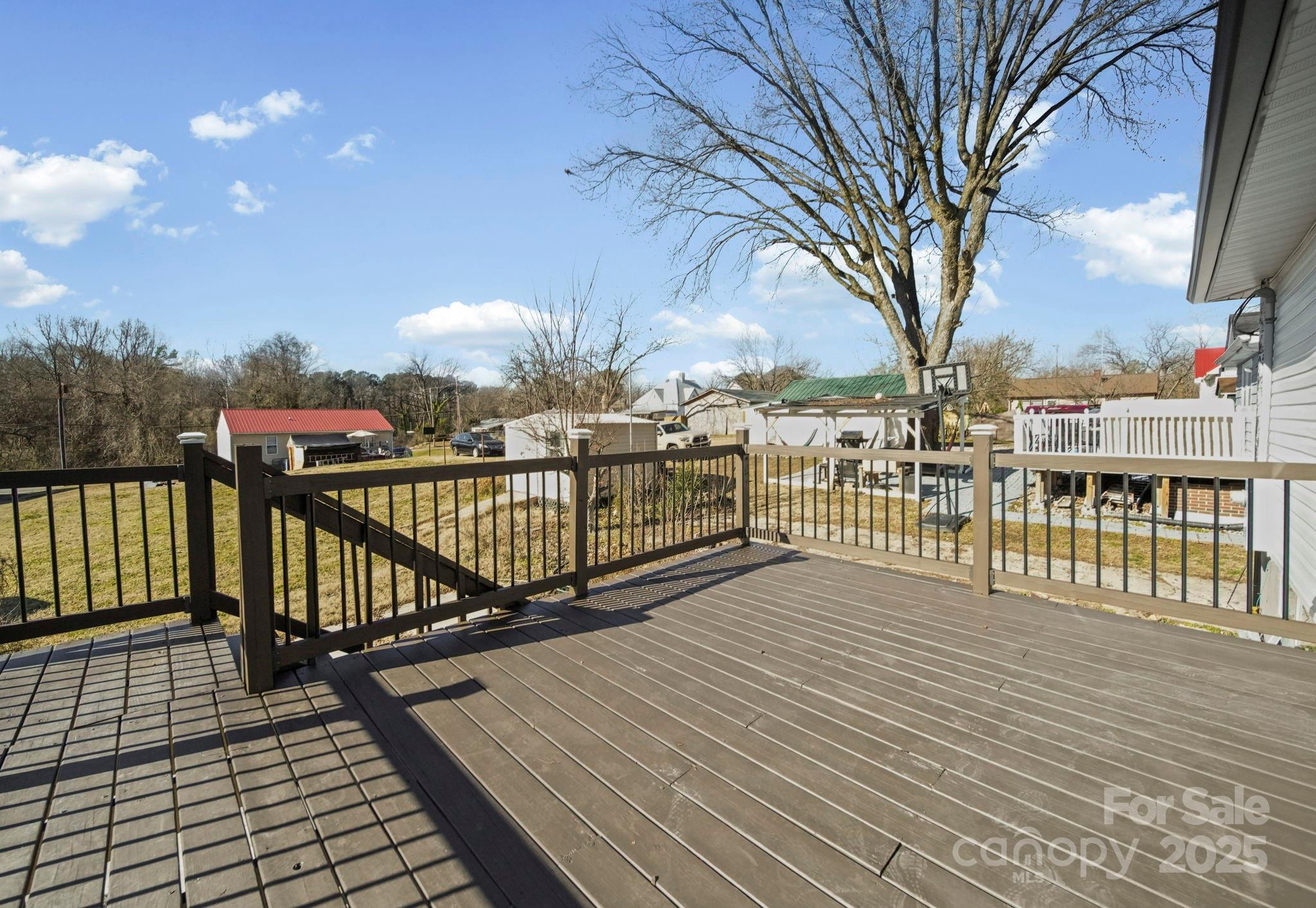 113 7th Street Spencer, NC 28159 - Photo 43 of 44 a view of a balcony with wooden floor and fence