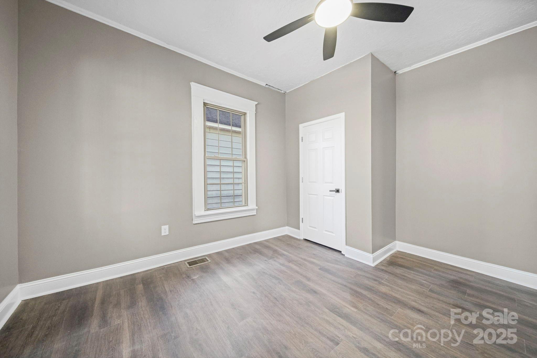 113 7th Street Spencer, NC 28159 - Photo 5 of 44 wooden floor in an empty room with a window