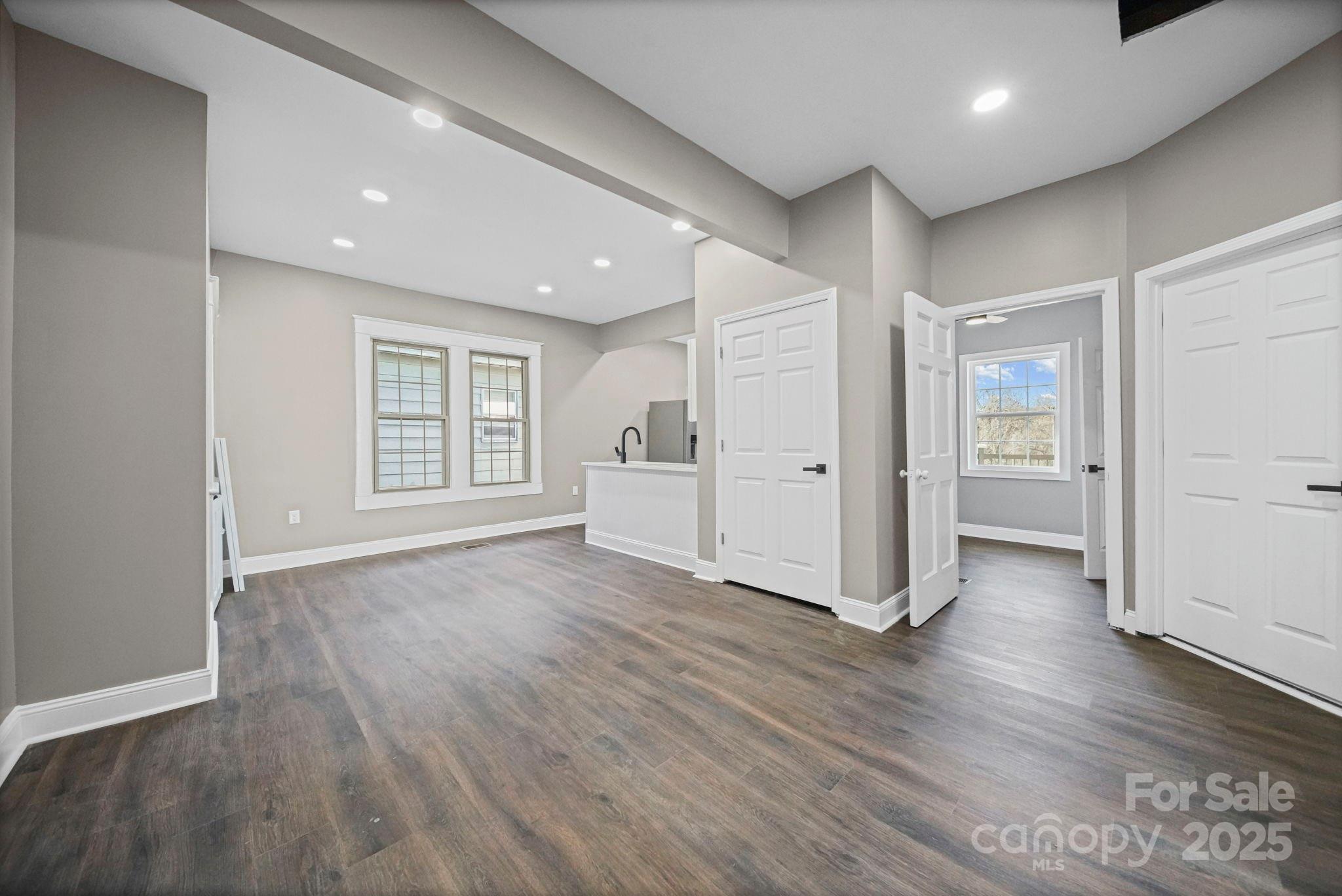 113 7th Street Spencer, NC 28159 - Photo 6 of 44 an empty room with wooden floor & closet and windows