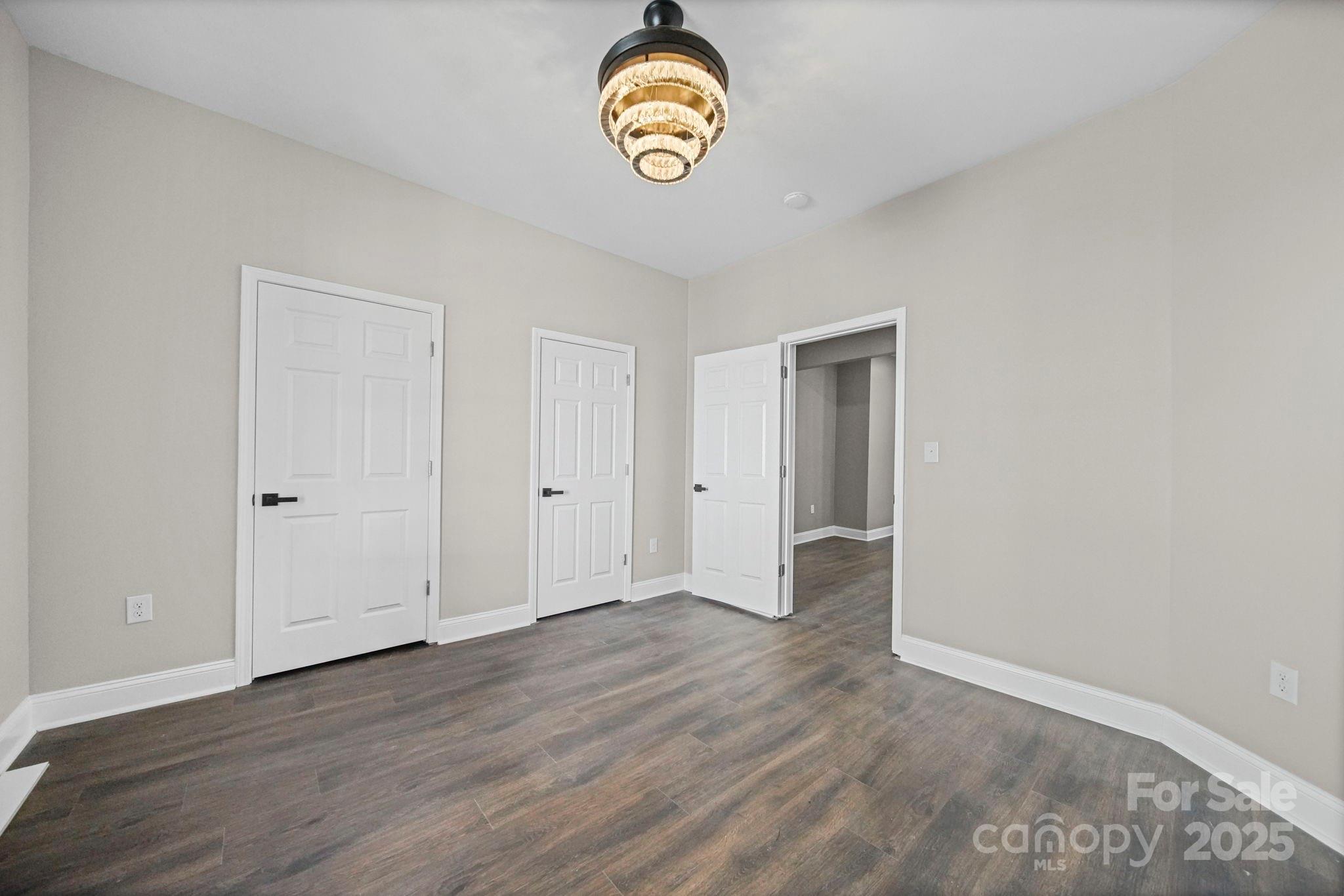 113 7th Street Spencer, NC 28159 - Photo 7 of 44 a view of an empty room with wooden floor and window