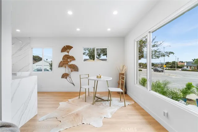 a living room with furniture and a floor to ceiling window