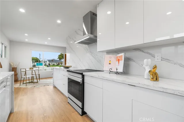 a kitchen with a sink a stove cabinets and counter space
