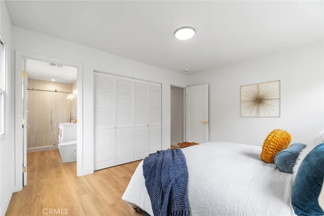 a bedroom with a bed and a painting on the wall