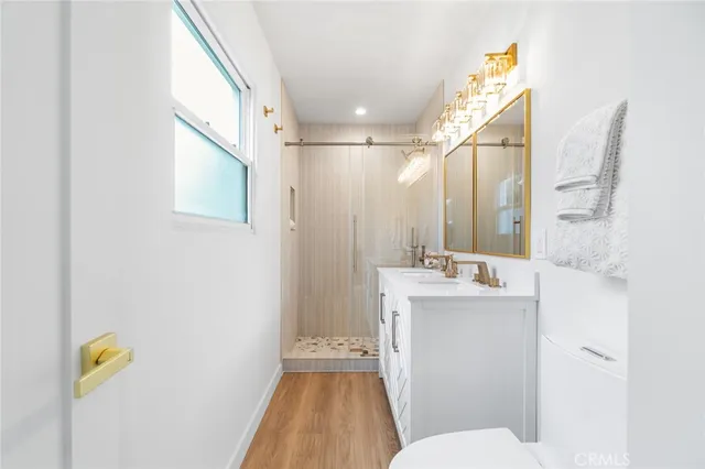 a bathroom with a sink a toilet and shower