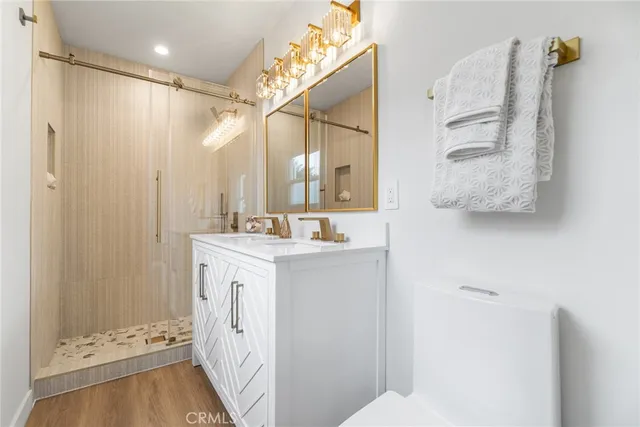 a bathroom with a double vanity sink mirror and shower