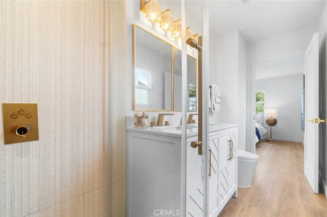 a bathroom with a sink and mirror with toilet
