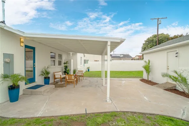 a view of a house with backyard porch and sitting area