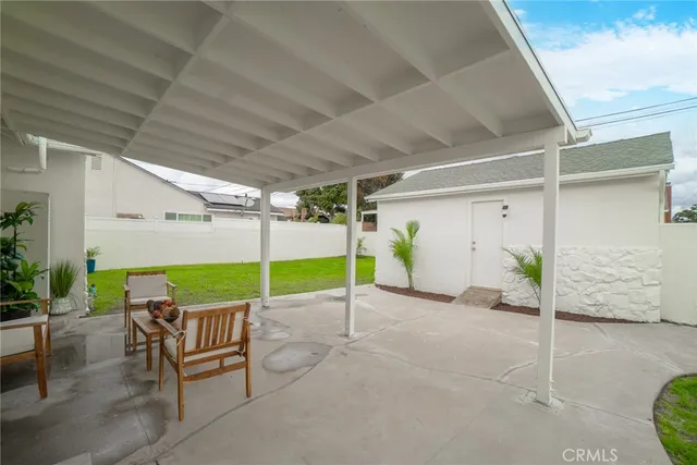 a view of a porch with furniture and a yard