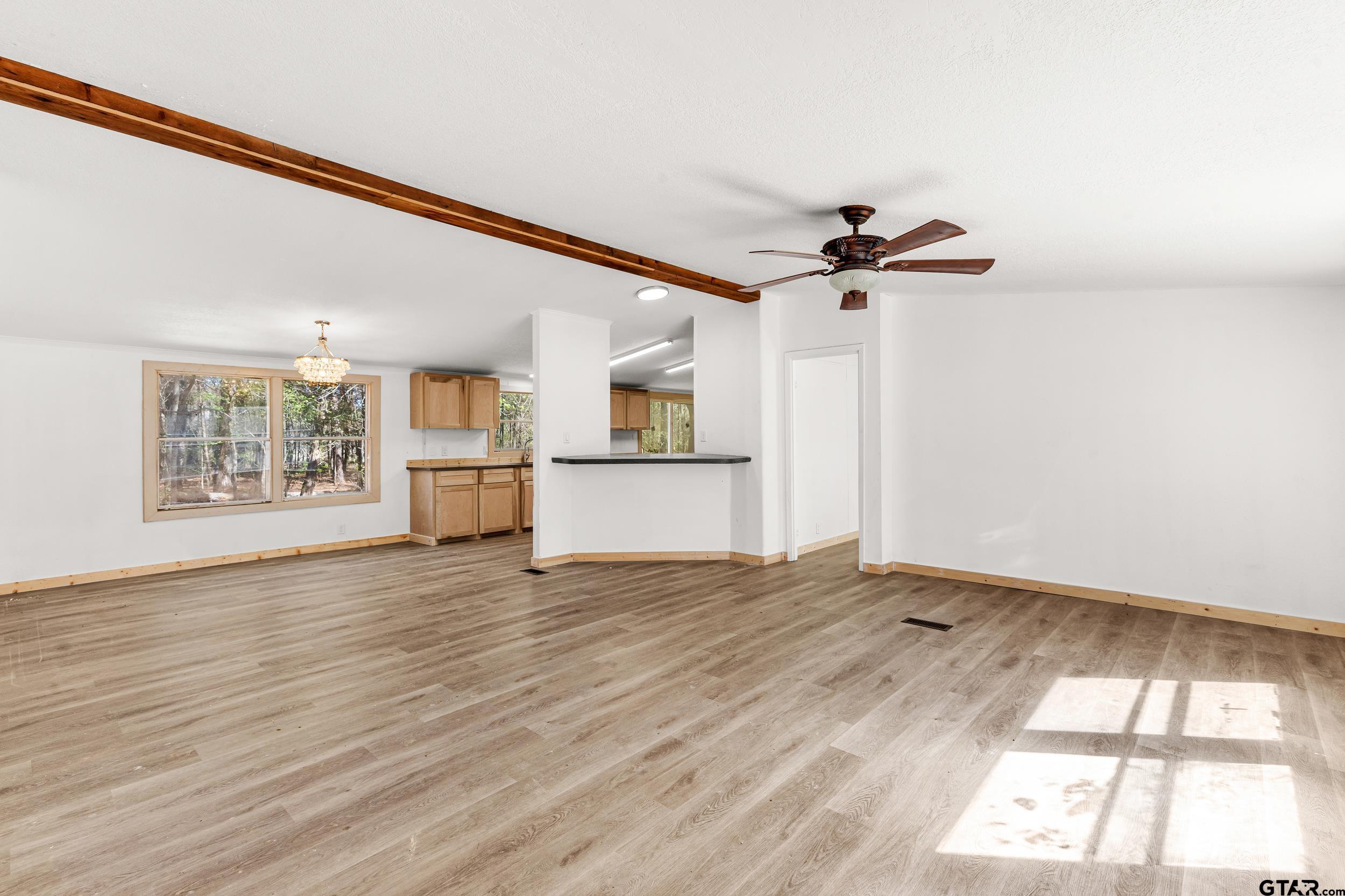 180 Southeast County Road Southeast Mount Vernon, TX 75457 - Photo 6 of 32 wooden floor in an empty room with a window