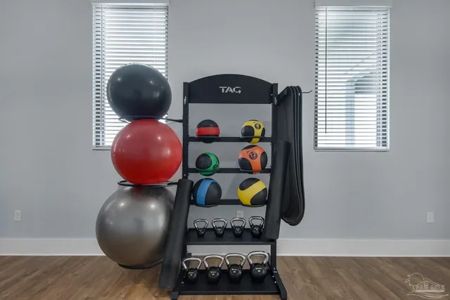 a dining room with furniture and a chandelier fan