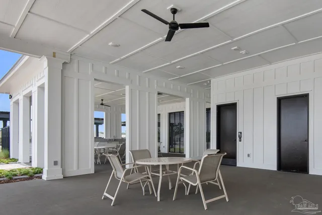 a dining room with furniture and a kitchen view