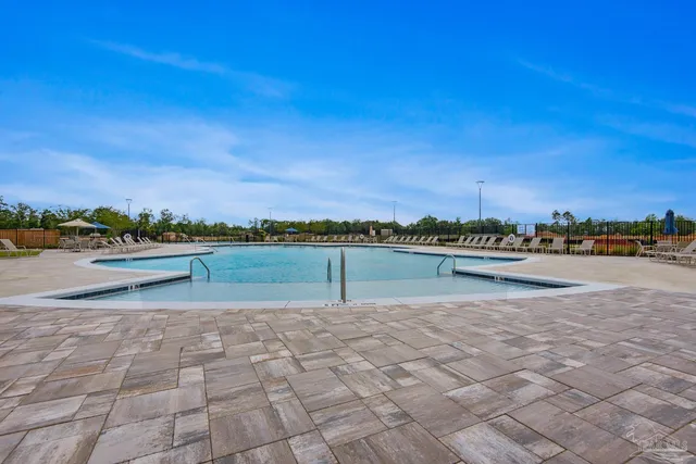 a view of swimming pool with outdoor seating and yard
