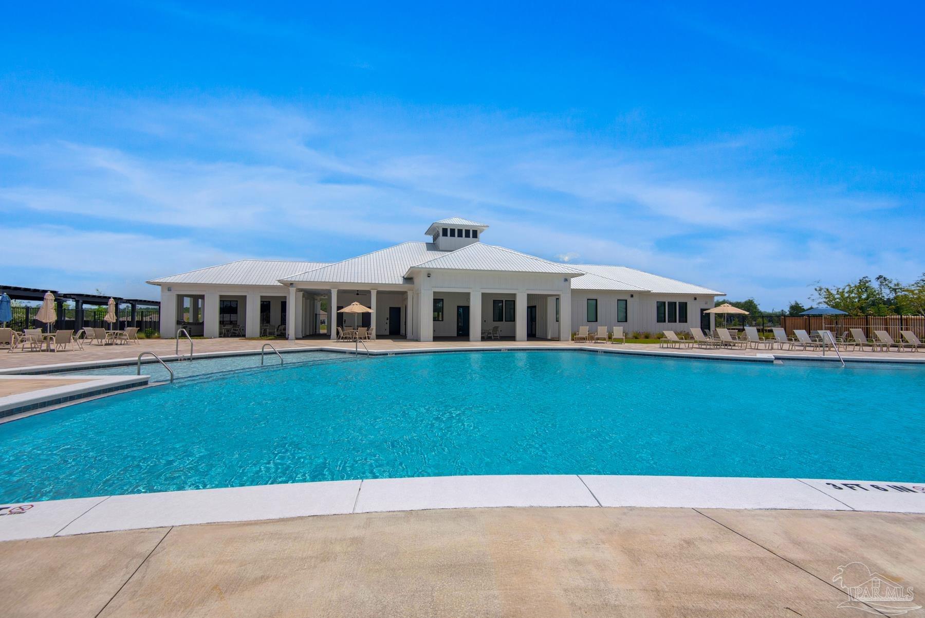 4671 Eider Road Pace, FL 32571 - Photo 4 of 37 a front view of a house with a garden