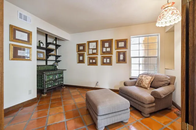 a en suite bathroom with a granite countertop sink and a mirror