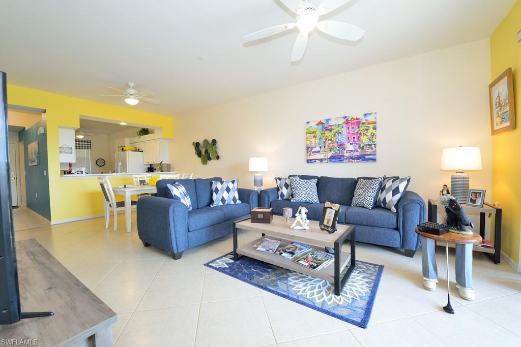 3830 Sawgrass Way, Unit 2934 Naples, FL 34112 - Photo 4 of 16 a living room with furniture and a chandelier