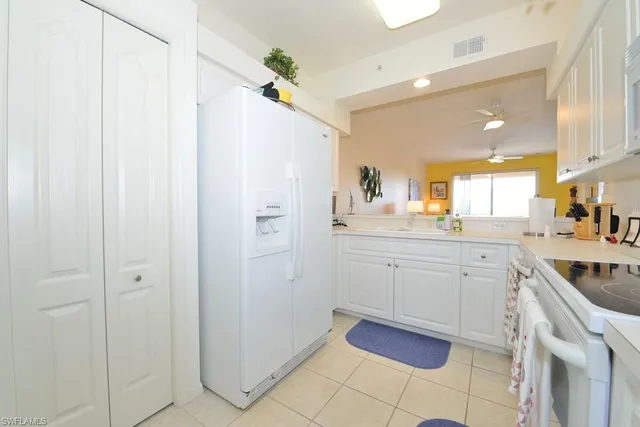 a kitchen with a sink cabinets and appliances