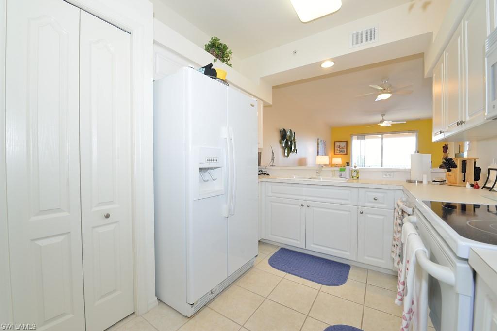 3830 Sawgrass Way, Unit 2934 Naples, FL 34112 - Photo 6 of 16 a kitchen with a sink cabinets and appliances