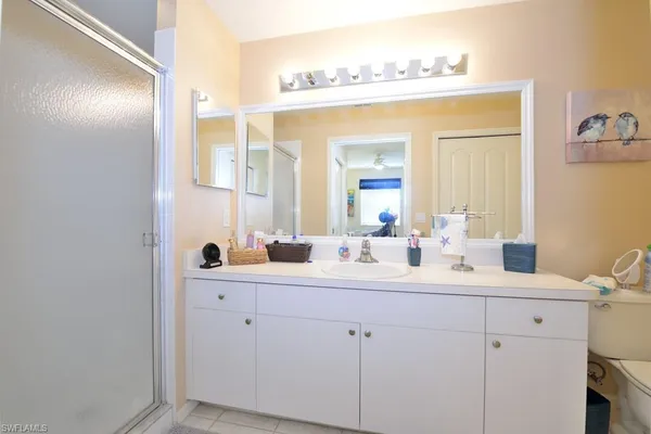 a bathroom with a double vanity sink and a mirror
