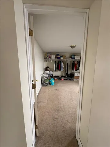 a spacious bedroom with a bed and a chandelier