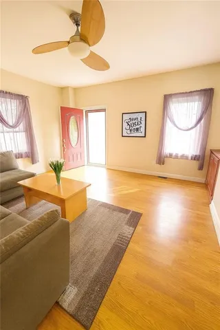 a living room with couches and a chandelier