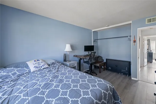 a bedroom with a bed and a tv on table