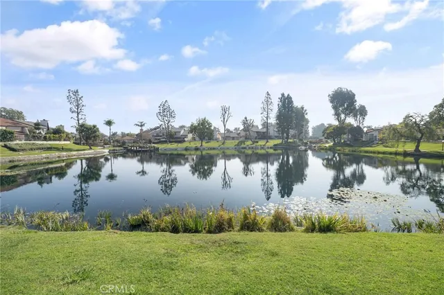 a view of a lake with houses in the back