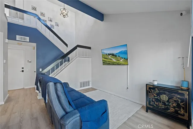 a living room with furniture and stairs