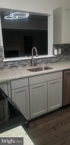 a view of a room with wooden floor and window