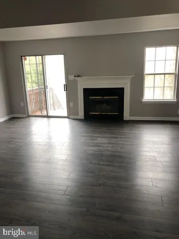 a kitchen with granite countertop a refrigerator and a stove top oven