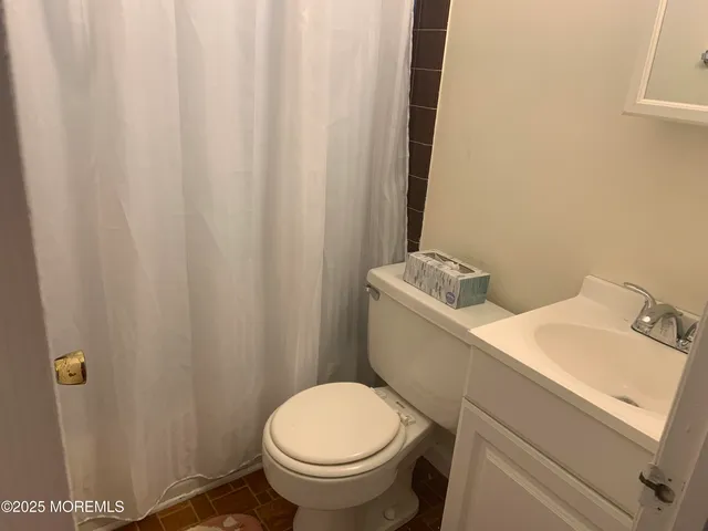 a white toilet sitting next to a small bathroom