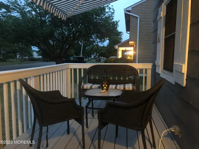 a view of balcony with wooden floor and outdoor seating