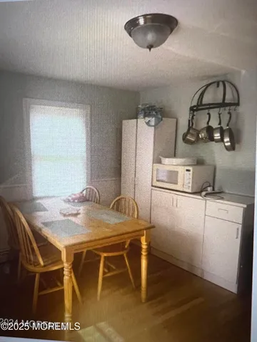 a view of a dining room with furniture and a chandelier