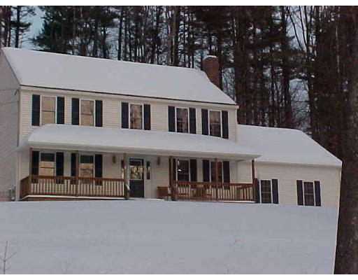 44 Fairview Park Road Sturbridge, MA 01566 - Photo 1 of 7 a aerial view of a brick house with large windows and a small yard