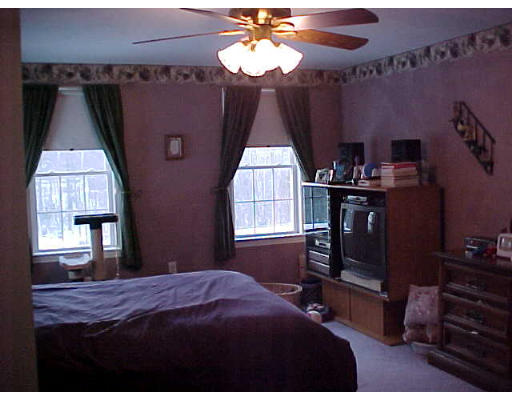 44 Fairview Park Road Sturbridge, MA 01566 - Photo 7 of 7 a bedroom with a bed and a chandelier