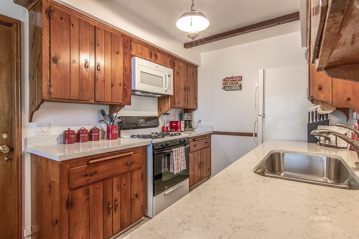 54440 Valley-View Idyllwild, CA 92549 - Photo 19 of 53 a kitchen with stainless steel appliances granite countertop a sink stove and cabinets