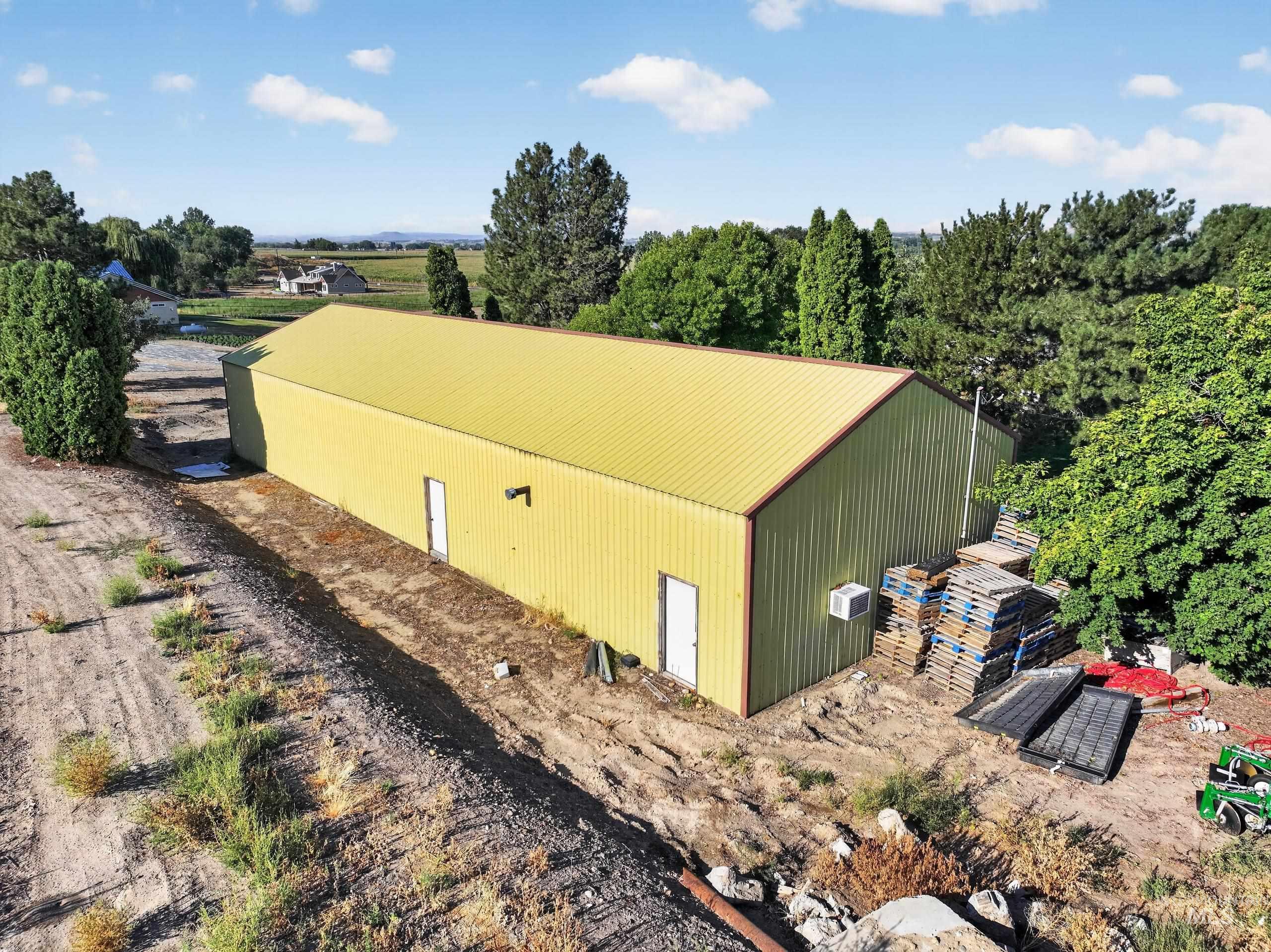 5540 Finley Road Fruitland, ID 83619 - Photo 11 of 50 Open-air with a metal roof and a wooden frame, complemented by a wooden fence structure