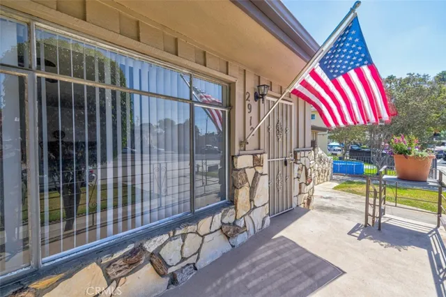 a view of empty room with wooden floor and fireplace