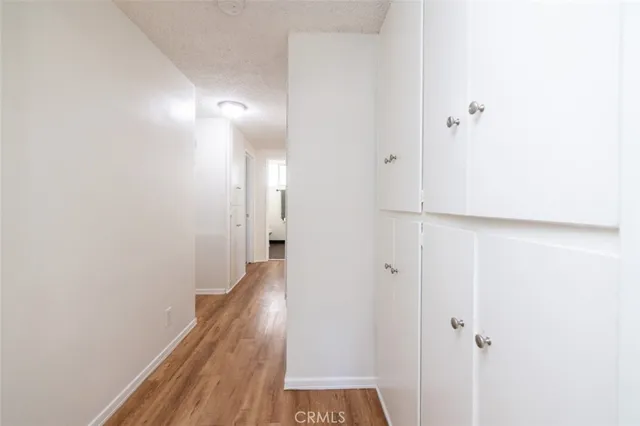an empty room with a ceiling fan and wooden floor