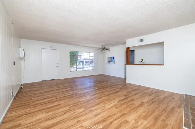 a kitchen with white cabinets and window